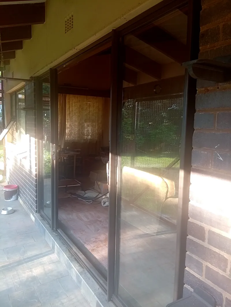 Bronze sliding doors opening the lounge onto the garden